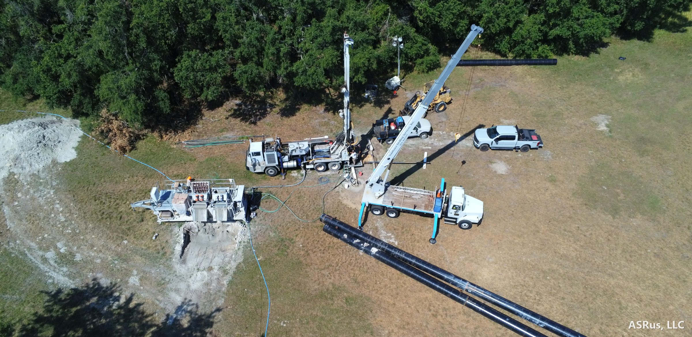 Aerial view of the drill rig, support truck, and staged casing at the Pollard Road supply well site